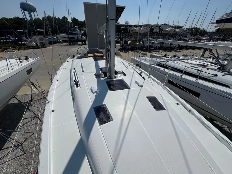 Slide: The Image of 2024 Beneteau First 44 sailboat on display at a marina, showcasing sleek deck design. - 1