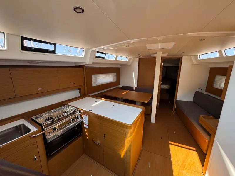 Slide: The Image of 2024 Beneteau First 44 yacht interior with modern kitchen and seating area. - 21