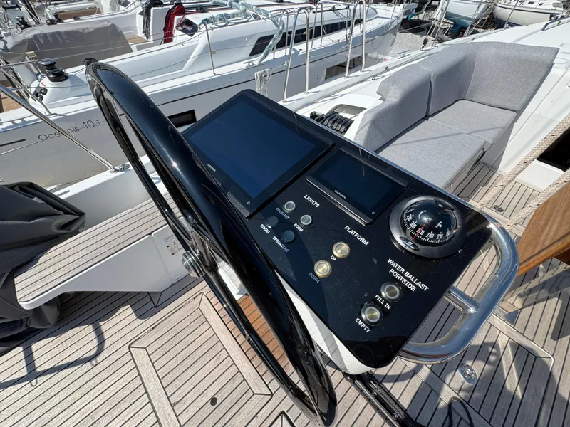 Slide: The Image of Cockpit of 2024 Beneteau First 44 sailboat with modern navigation controls and seating. - 3