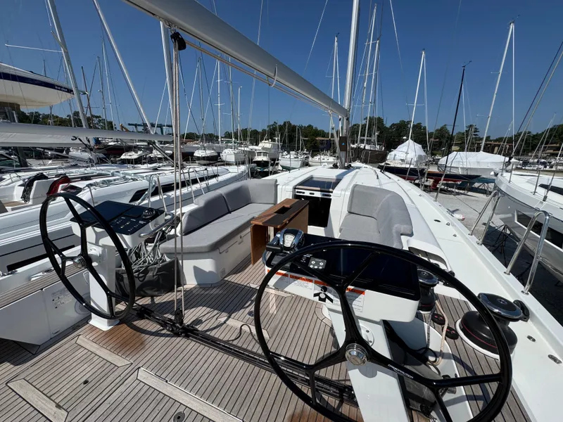 Slide: The Image of 2024 Beneteau First 44 sailboat cockpit with dual steering wheels and spacious seating. - 5
