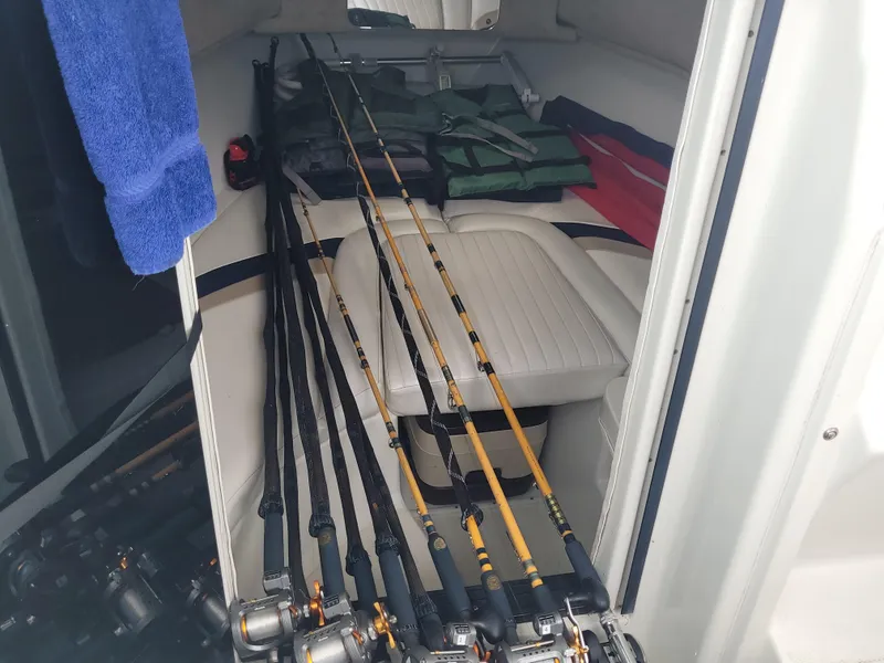 Slide: The Image of Interior of 2003 Caravelle Sea Hawk 230 with fishing rods and gear. - 14
