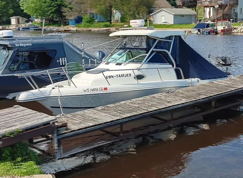 Slide: The Image of 2003 Caravelle Sea Hawk 230 Walk Around OB docked by a lakeside. - 4