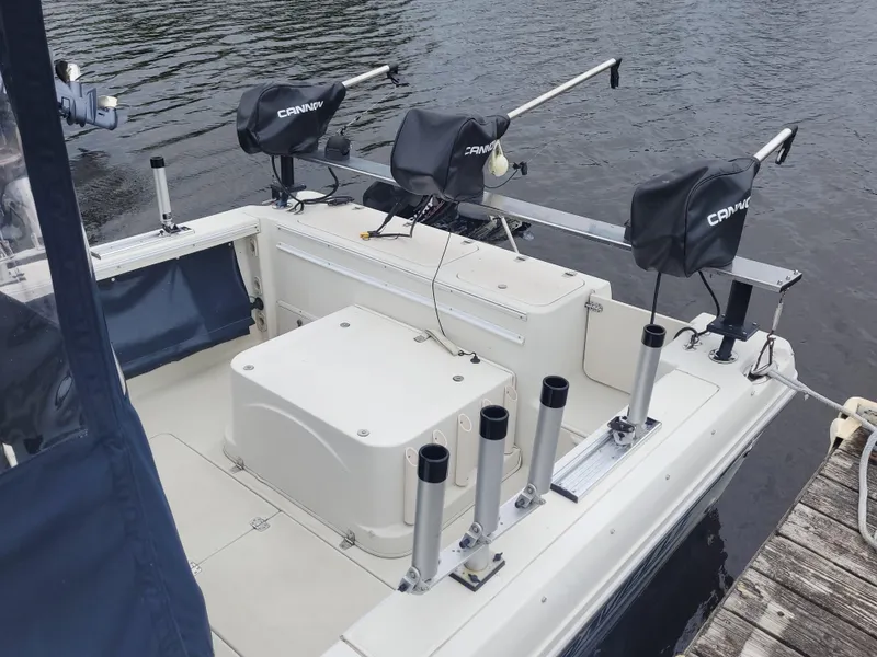 Slide: The Image of 2003 Caravelle Sea Hawk 230 Walk Around OB boat with fishing rod holders and downriggers. - 7