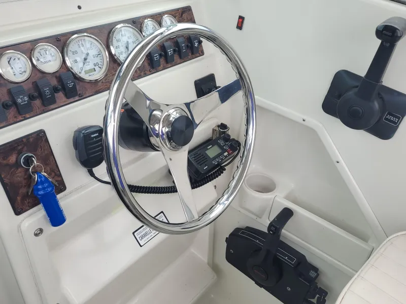 Slide: The Image of Steering console of 2003 Caravelle Sea Hawk 230 Walk Around OB with gauges and controls. - 9