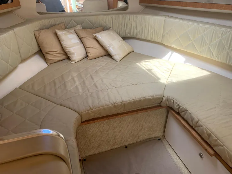 Slide: The Image of Interior cabin of 2006 Sea Ray 280 Sundancer with beige cushions and pillows. - 13