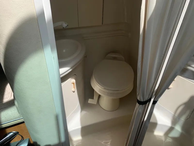 Slide: The Image of 2006 Sea Ray 280 Sundancer bathroom with toilet and sink. - 15