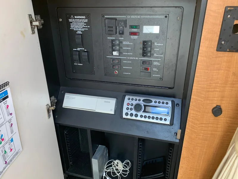 Slide: The Image of Electrical control panel of 2006 Sea Ray 280 Sundancer boat, featuring switches and stereo system. - 18