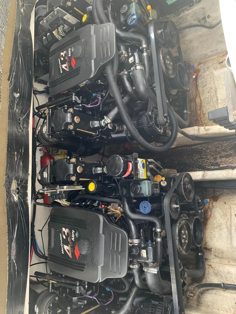 Slide: The Image of Twin engines of a 2006 Sea Ray 280 Sundancer boat, showcasing detailed mechanics. - 20