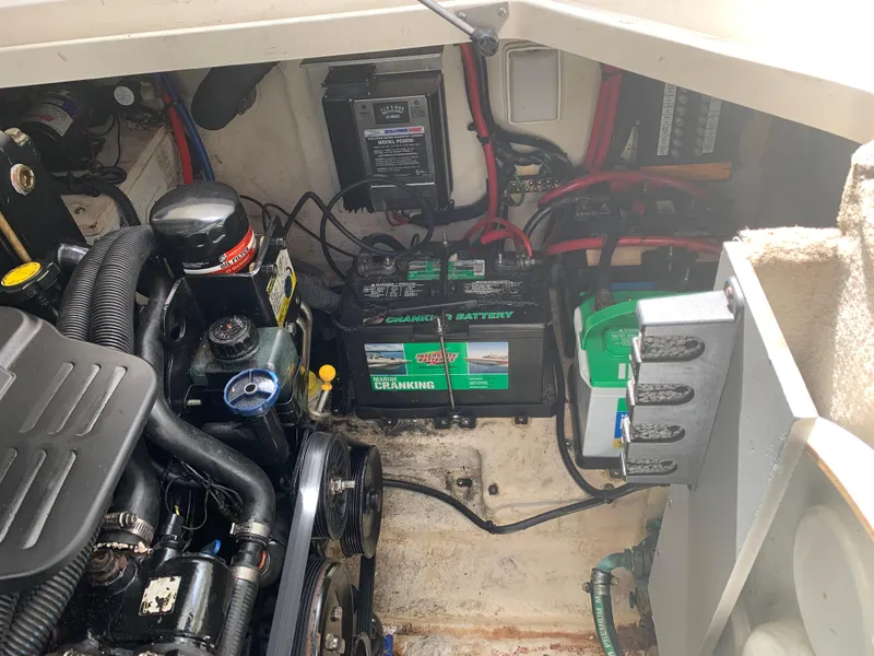 Slide: The Image of Engine compartment of a 2006 Sea Ray 280 Sundancer with visible battery and wiring. - 23