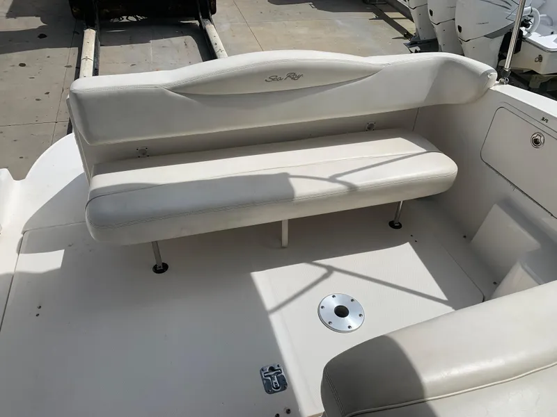 Slide: The Image of 2006 Sea Ray 280 Sundancer boat interior with white seating and clean deck. - 3