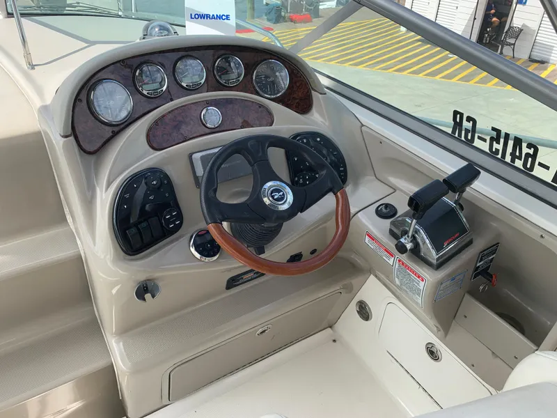 Slide: The Image of 2006 Sea Ray 280 Sundancer helm with steering wheel and control panel. - 4