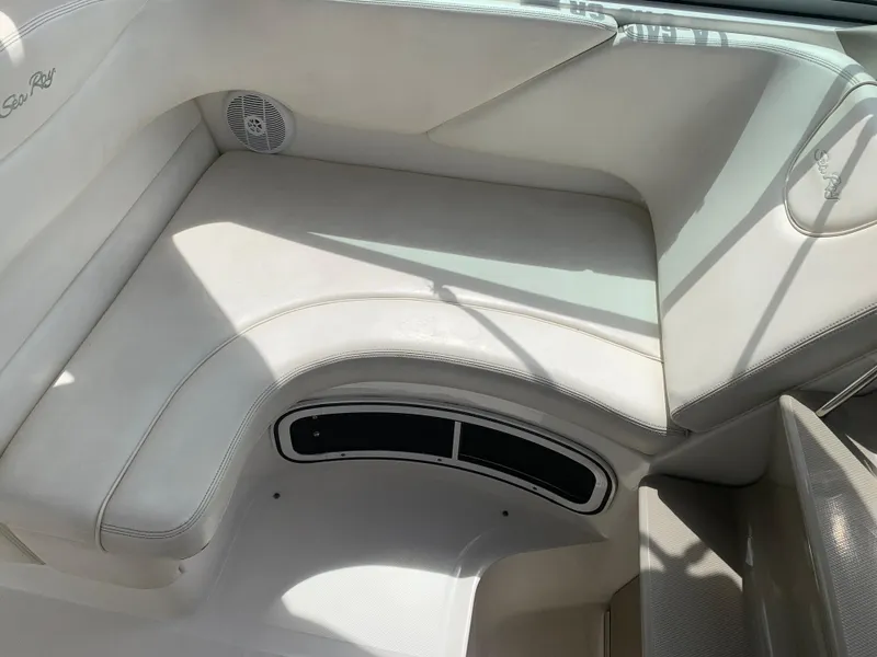 Slide: The Image of 2006 Sea Ray 280 Sundancer interior seating with speaker and storage compartment. - 9
