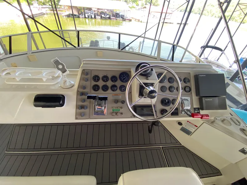 Slide: The Image of 1997 Carver 405 Motor Yacht interior with white seating and helm station. - 12