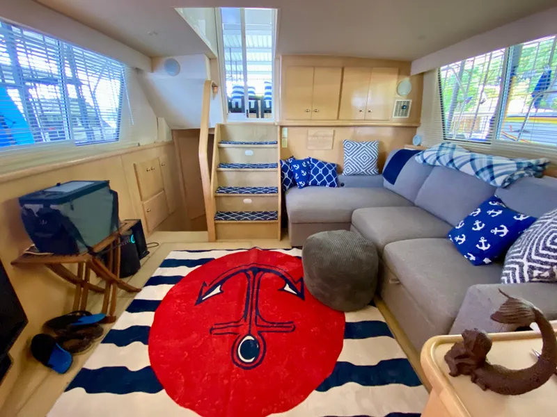 Slide: The Image of Interior of 1997 Carver 405 Motor Yacht with cozy seating and nautical decor. - 21