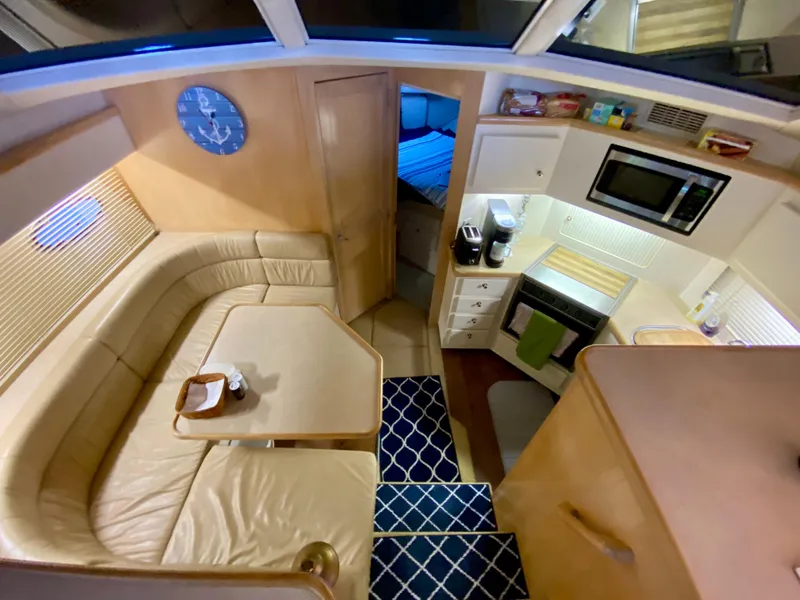 Slide: The Image of Interior of 1997 Carver 405 Motor Yacht with stairs, TV, and nautical decor. - 22