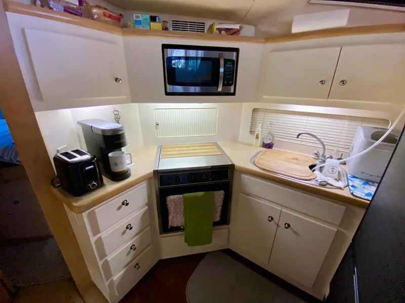 Slide: The Image of Interior of 1997 Carver 405 Motor Yacht with kitchen and seating area. - 24