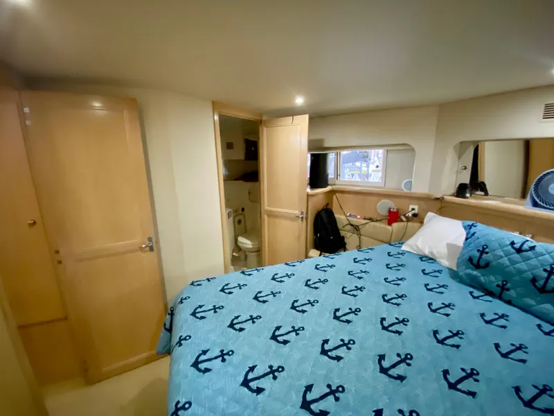 Slide: The Image of Interior of 1997 Carver 405 Motor Yacht with wooden cabinet and bed. - 31