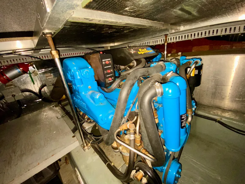 Slide: The Image of Engine room of 1997 Carver 405 Motor Yacht with blue engine components. - 43