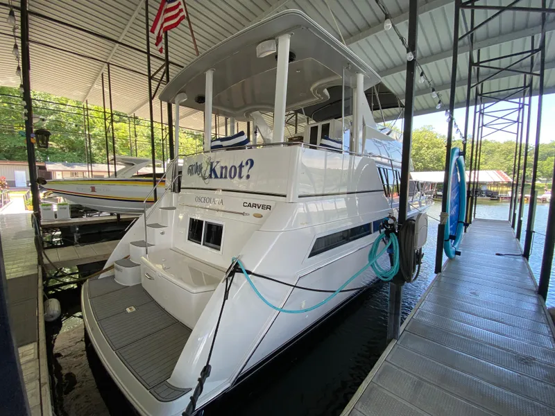 Slide: The Image of 1997 Carver 405 Motor Yacht interior with striped seating and modern amenities. - 5