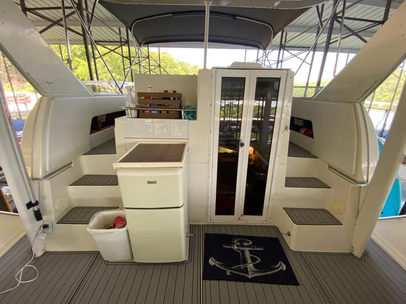 Slide: The Image of 1997 Carver 405 Motor Yacht helm with dual seats, steering wheel, and control panel. - 8