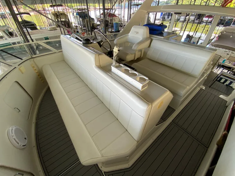 Slide: The Image of 1997 Carver 405 Motor Yacht interior with white seating and helm station. - 10