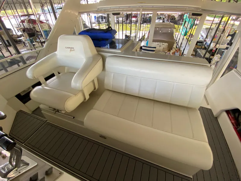Slide: The Image of 1997 Carver 405 Motor Yacht helm with steering wheel, gauges, and controls. - 11