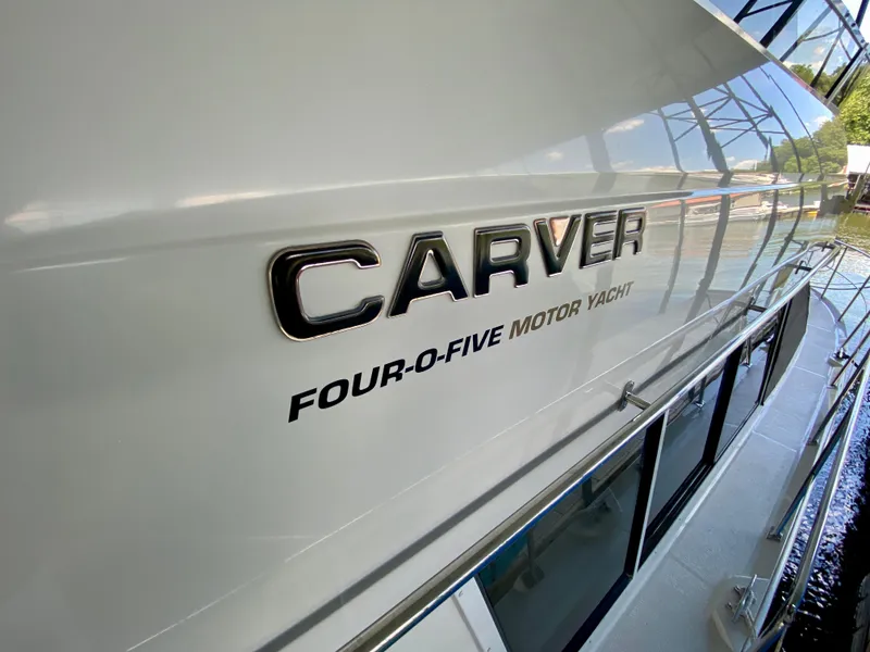 Slide: The Image of 1997 Carver 405 Motor Yacht docked at marina, view of bow and surrounding water. - 14
