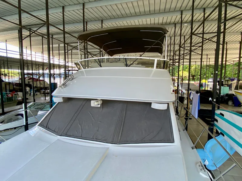 Slide: The Image of Interior of 1997 Carver 405 Motor Yacht with cozy seating and nautical decor. - 17