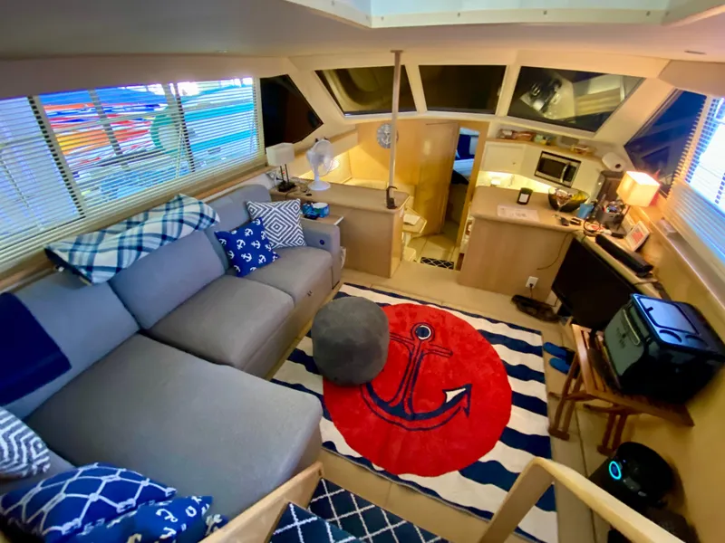 Slide: The Image of Luxurious interior of 1997 Carver 405 Motor Yacht with cozy seating and nautical decor. - 18