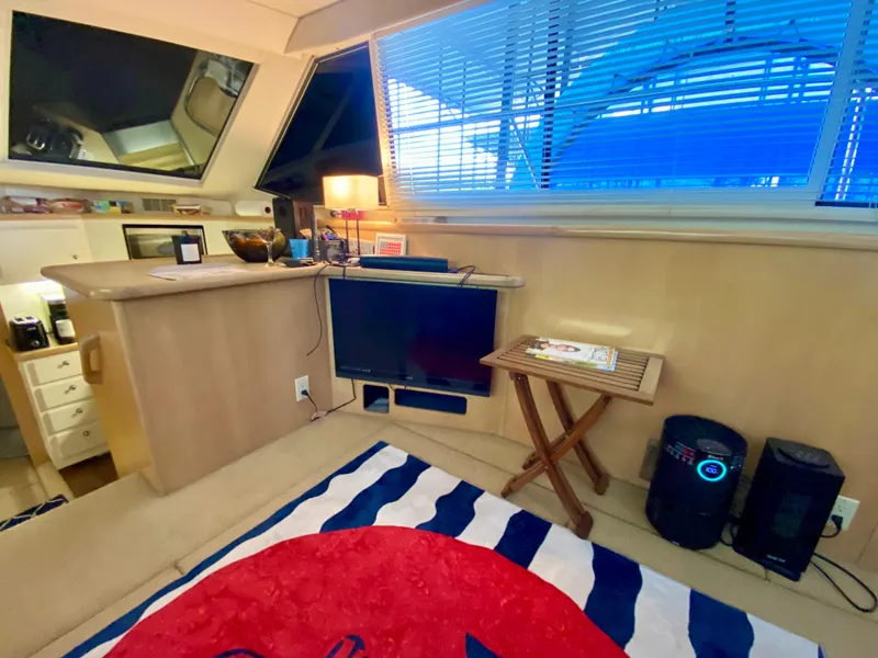 Slide: The Image of Luxurious 1997 Carver 405 Motor Yacht interior with nautical-themed decor and cozy seating. - 20