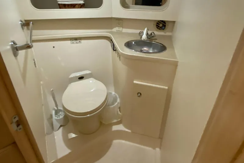 Slide: The Image of 1997 Carver 405 Motor Yacht kitchen with appliances, sink, and storage cabinets. - 28