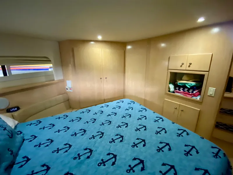 Slide: The Image of Cozy cabin interior of 1997 Carver 405 Motor Yacht with anchor-themed blanket. - 30