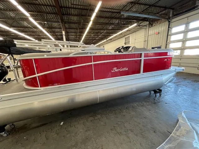 The Image of 2025 Barletta ARIA 20QC pontoon boat in a showroom, featuring a sleek red exterior. - 0