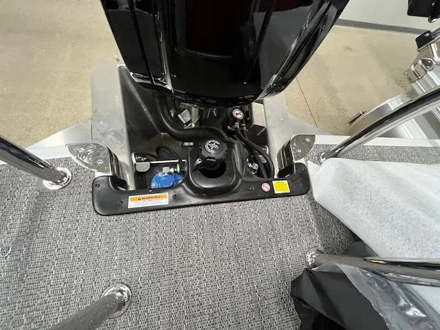 Slide: The Image of 2025 Barletta ARIA 20QC boat engine compartment with carpeted flooring and metal railings. - 10