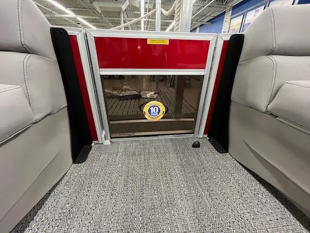 Slide: The Image of 2025 Barletta ARIA 20QC interior with gray seating and red paneling, showcasing a 10-year warranty badge. - 15