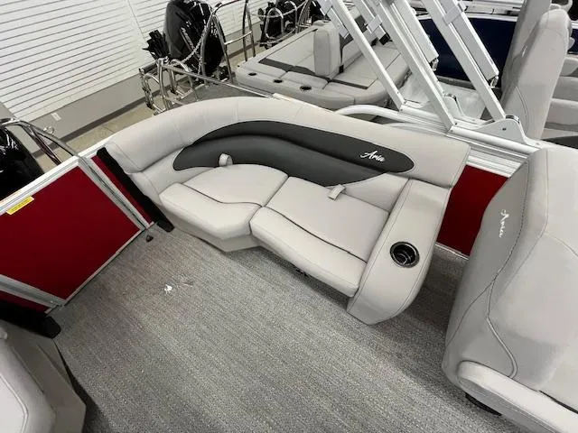 Slide: The Image of 2025 Barletta ARIA 20QC pontoon boat interior with gray seating and red paneling. - 22