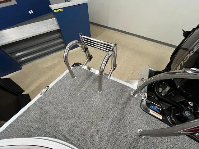 Slide: The Image of Alt text: "2025 Barletta ARIA 20QC boat ladder and engine detail in showroom." - 9