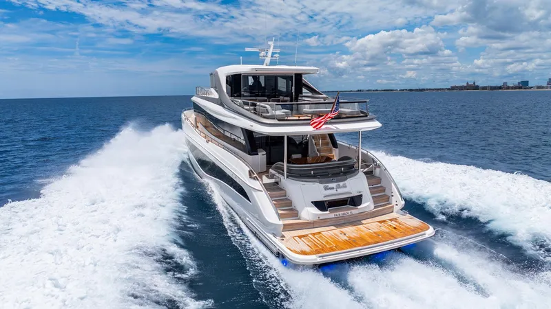 Slide: The Image of 2024 Princess X80 yacht cruising on open sea under a clear blue sky. - 10