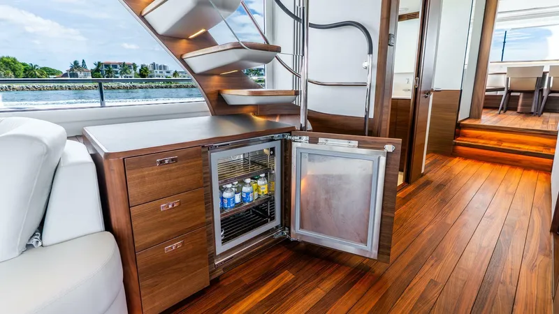 Slide: The Image of Luxurious 2024 Princess X80 yacht interior with wooden flooring and open mini fridge. - 15