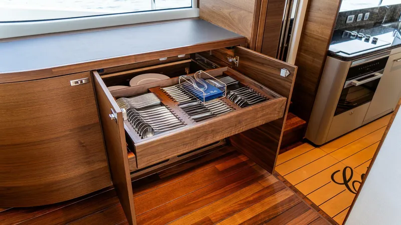 Slide: The Image of Luxurious kitchen drawer with organized cutlery on the 2024 Princess X80 yacht. - 19