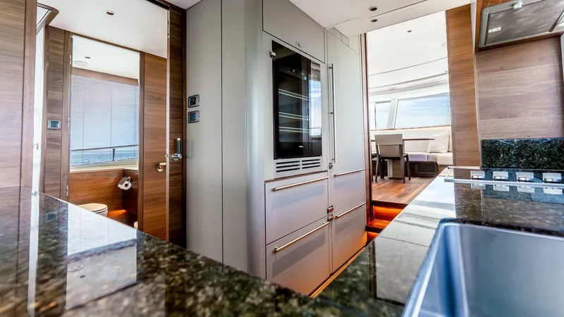 Slide: The Image of Luxurious interior of 2024 Princess X80 yacht featuring modern kitchen and dining area. - 22