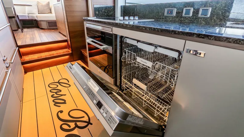 Slide: The Image of Modern kitchen in 2024 Princess X80 yacht with open dishwasher and sleek design. - 24