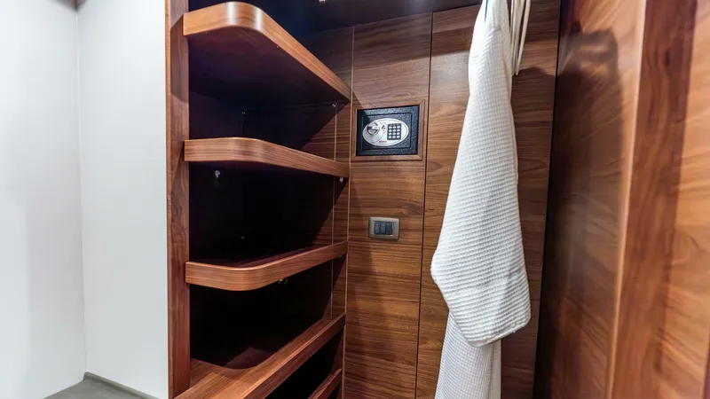 Slide: The Image of Luxurious wooden closet with safe and robe in 2024 Princess X80 yacht. - 35