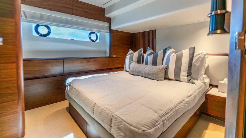 Slide: The Image of Luxurious bedroom interior of 2024 Princess X80 yacht with striped pillows and wooden accents. - 41