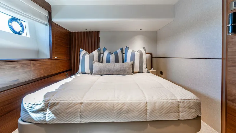 Slide: The Image of Luxurious bedroom interior of 2024 Princess X80 yacht with elegant bedding and wood accents. - 44