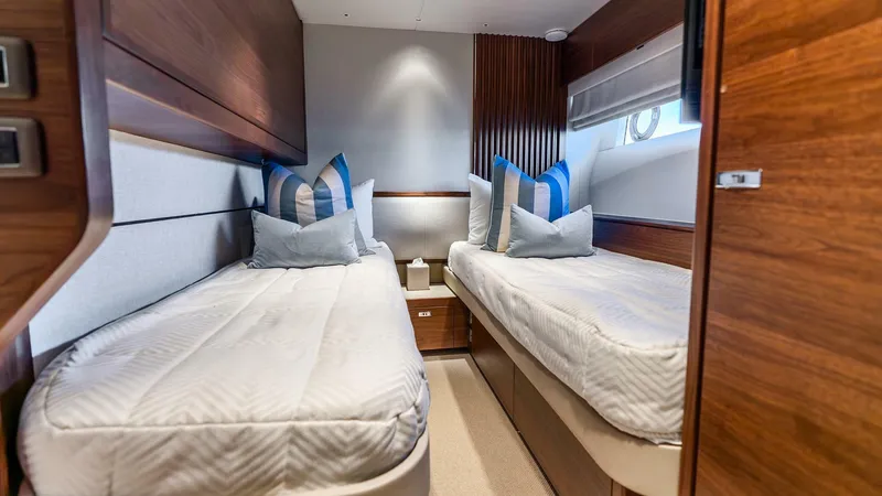 Slide: The Image of Luxurious twin cabin in 2024 Princess X80 yacht, featuring elegant wood finishes and plush bedding. - 45