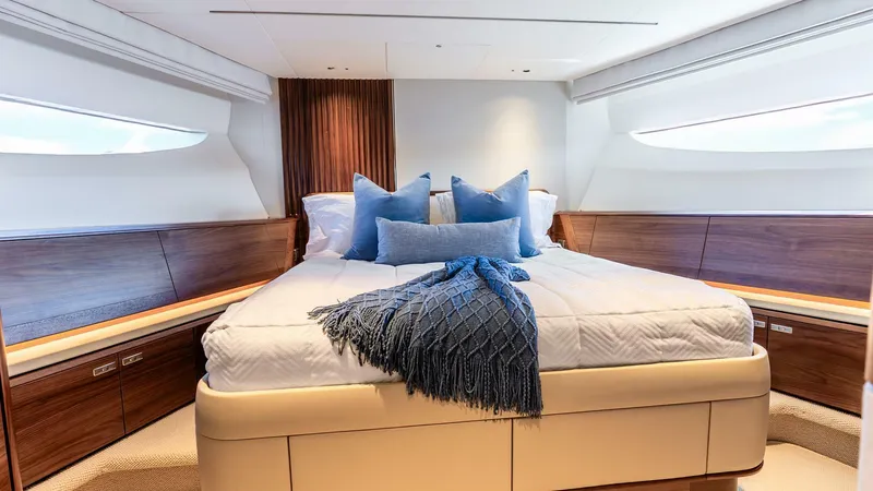 Slide: The Image of Luxurious bedroom interior of 2024 Princess X80 yacht with elegant wood finishes and plush bedding. - 48