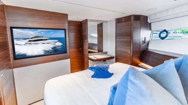 Slide: The Image of Luxurious 2024 Princess X80 yacht bedroom with modern wood paneling and elegant decor. - 49