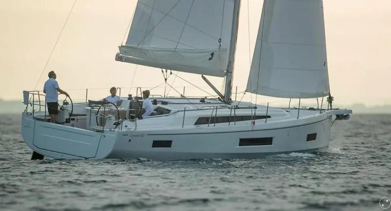 The Image of 2025 Beneteau Oceanis 40.1 sailing yacht on open water at sunset. - 0