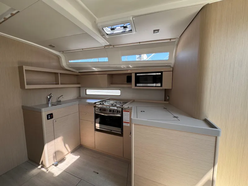 Slide: The Image of Modern kitchen interior of 2025 Beneteau Oceanis 40.1 yacht with light wood finish. - 11